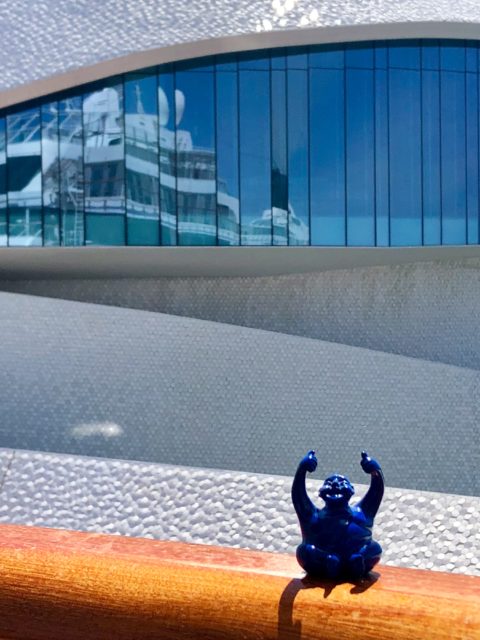 Syd on our balcony in Porto, Portugal. He thought the space-age passenger terminal in the background was far out!
